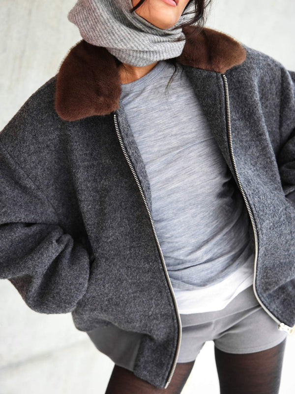 A model showcases a cozy gray oversized jacket with a brown fur collar, paired with a gray top and scarf, embodying MEOTINE's style.