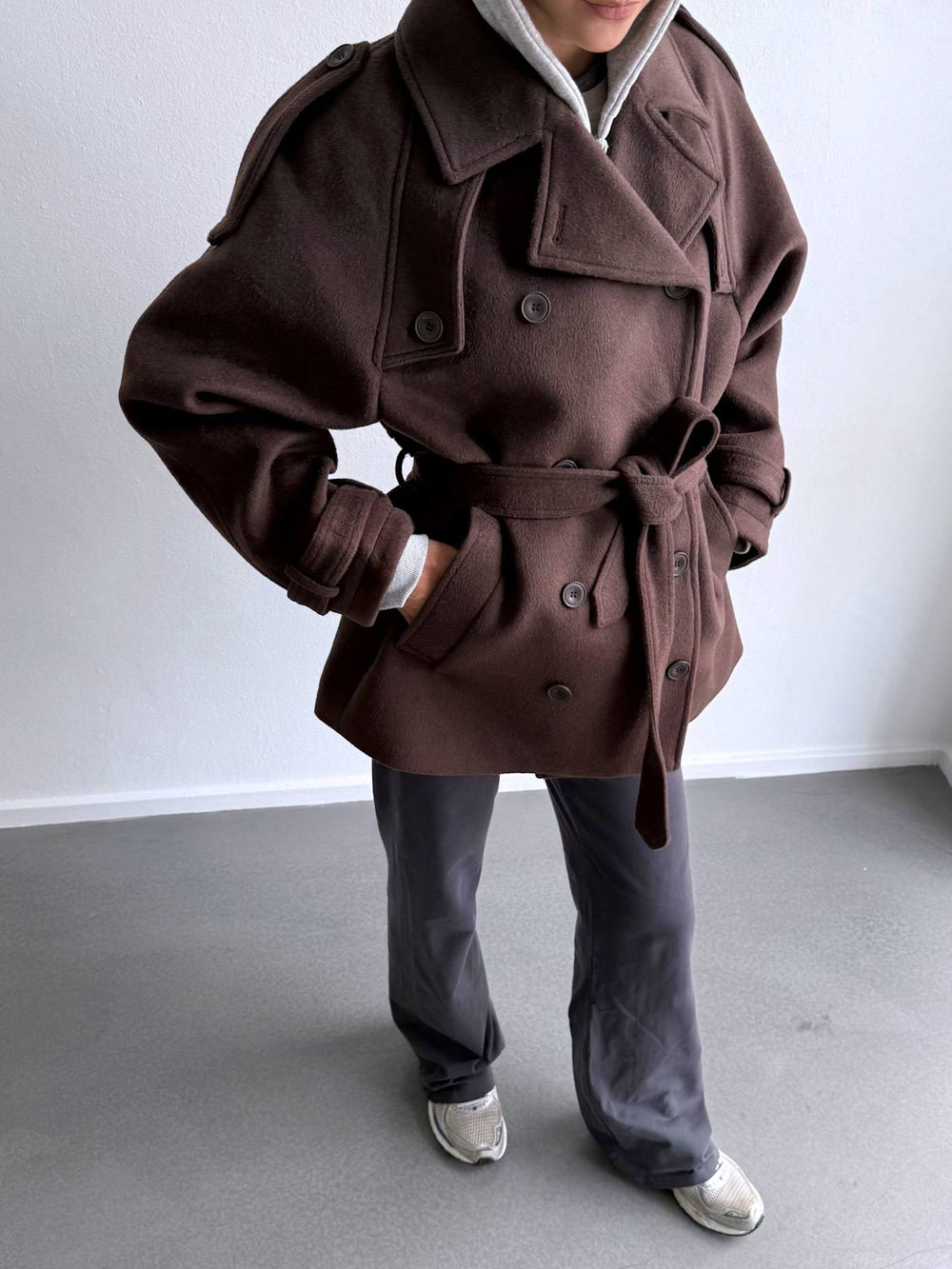 Stylish brown trench coat with a belted waist and double-breasted design, perfect for a chic look by MEOTINE.