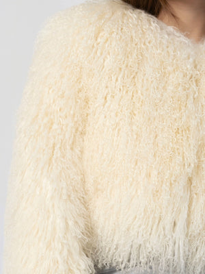 Soft, fluffy cream-colored sweater with a textured finish, perfect for cozy layering. Ideal for stylish winter outfits by MEOTINE.