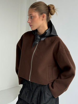 Stylish brown cropped jacket with a black leather hood, perfect for a chic look. Designed by MEOTINE for modern elegance.