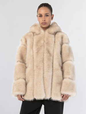 A model wears a luxurious beige faux fur coat with a hood, showcasing a stylish and cozy look by MEOTINE.