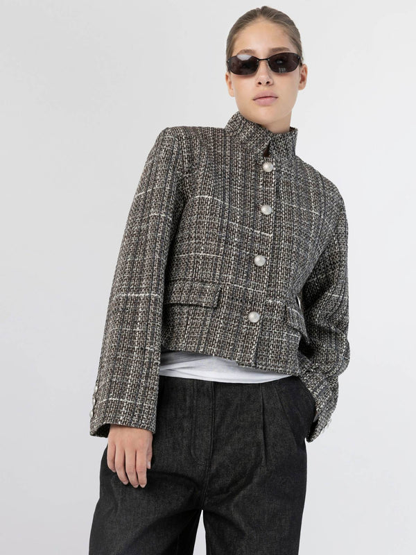 Chic cropped jacket with a textured pattern, featuring large buttons and a high collar, styled with dark trousers. MEOTINE.