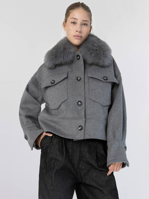 Stylish gray cropped jacket with a plush fur collar, featuring buttoned pockets, perfect for a chic winter look by MEOTINE.