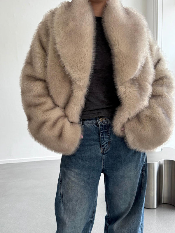 Cozy beige faux fur jacket with a wide collar, paired with casual blue jeans, showcasing a stylish look by MEOTINE.