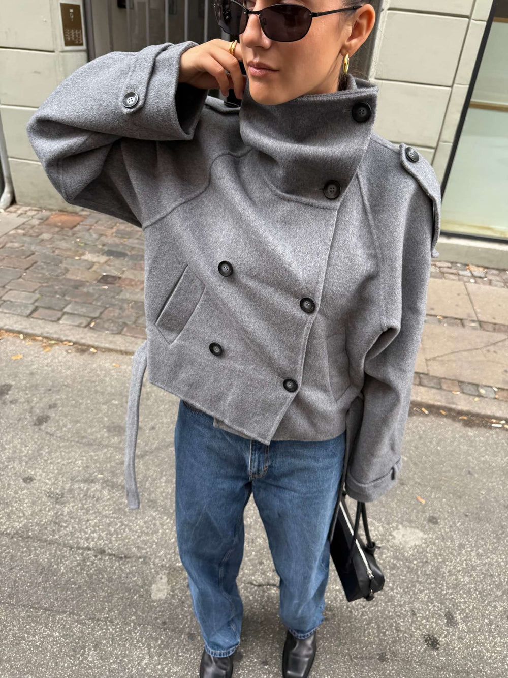Stylish gray trench coat with a belted waist and double-breasted design, showcasing a modern look by MEOTINE.