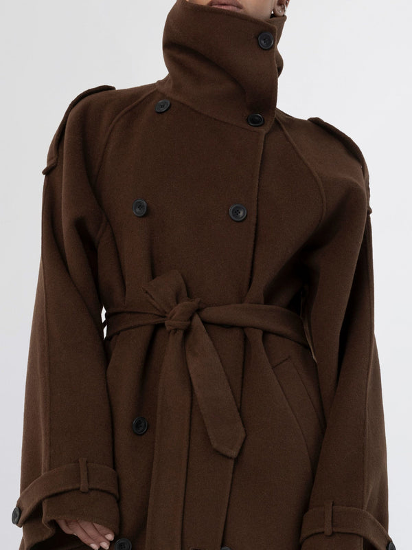 A stylish brown coat with a high collar and double-breasted buttons, featuring a belted waist, by MEOTINE.