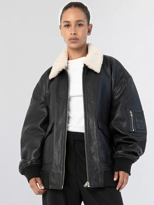 A model wears a stylish black leather jacket with a cozy white fur collar, showcasing MEOTINE's trendy design.