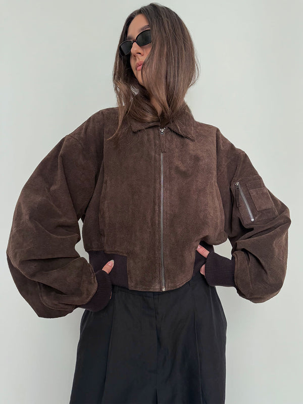 Brown cropped jacket with voluminous sleeves and a zippered pocket, styled with sunglasses, by MEOTINE.