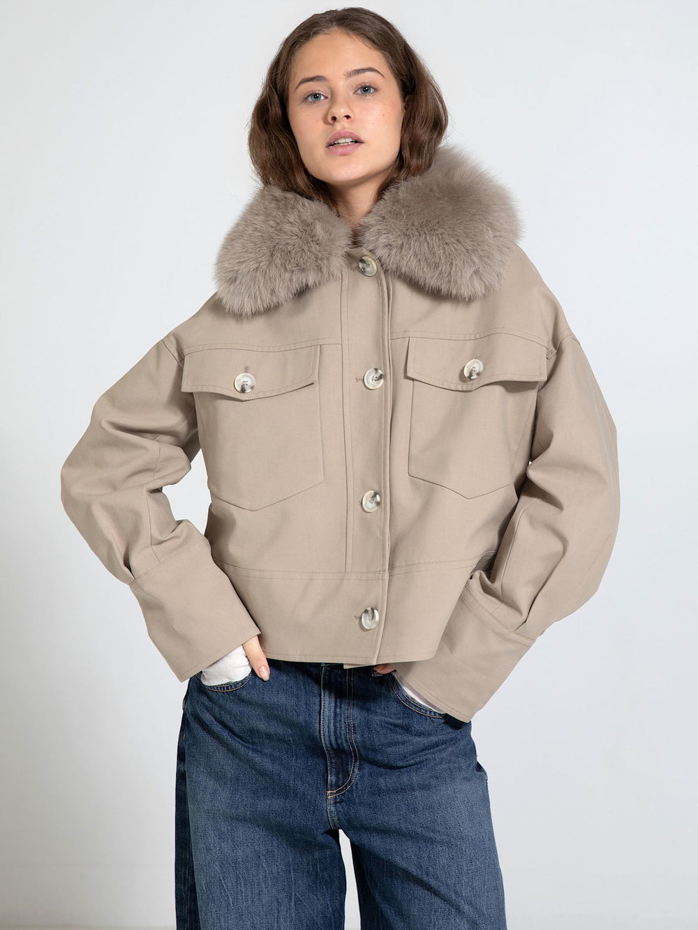 Stylish cropped jacket with a plush fur collar, featuring large pockets and a button-up front, perfect for a chic look by MEOTINE.
