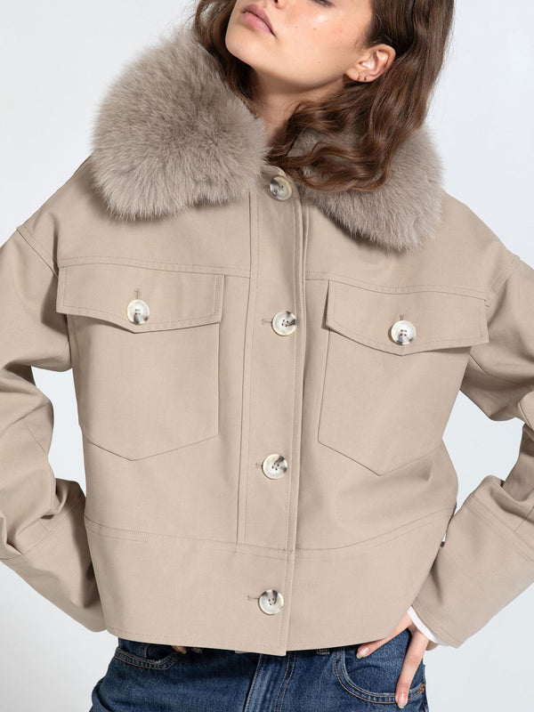 Stylish beige jacket with a plush fur collar, featuring large front pockets and button closure, perfect for a chic look by MEOTINE.