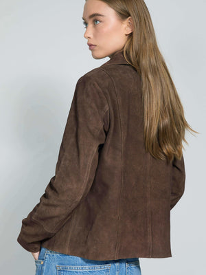 A model showcases a stylish brown suede jacket from MEOTINE, featuring a tailored fit and a chic, minimalist design.