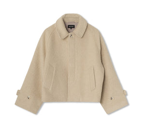 Beige textured jacket with a collared neckline and side pockets, featuring a relaxed fit. Designed by MEOTINE for a stylish look.