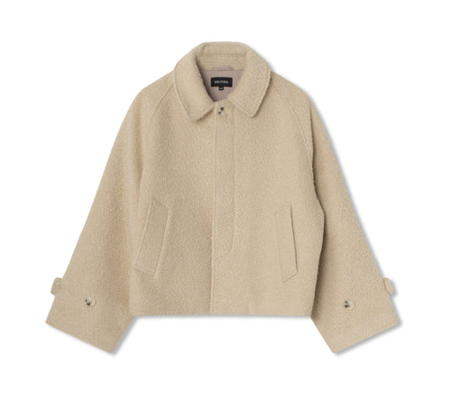 Beige textured jacket with a collared neckline and side pockets, featuring a relaxed fit. Designed by MEOTINE for a stylish look.