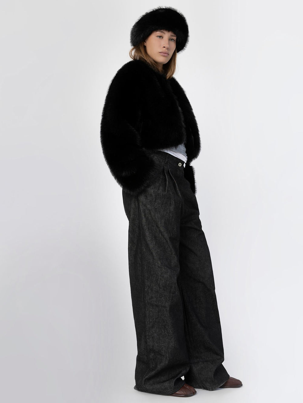 A model showcases a stylish black faux fur jacket paired with a matching hat, exuding elegance and warmth by MEOTINE.