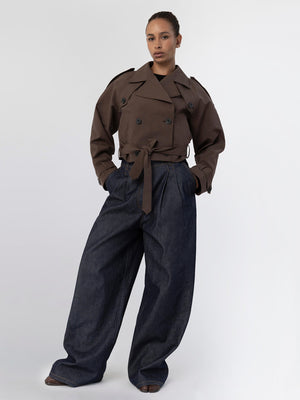 A model showcases a stylish brown double-breasted jacket paired with wide-leg denim pants, embodying MEOTINE's modern aesthetic.