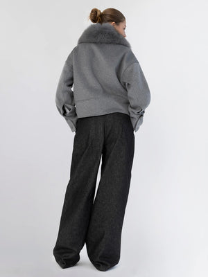 A model showcases a stylish gray cropped jacket with a fur collar, paired with wide-leg black trousers, embodying MEOTINE's chic aesthetic.