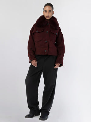 A model showcases a burgundy MEOTINE jacket with a fur collar, paired with loose black trousers against a neutral background.