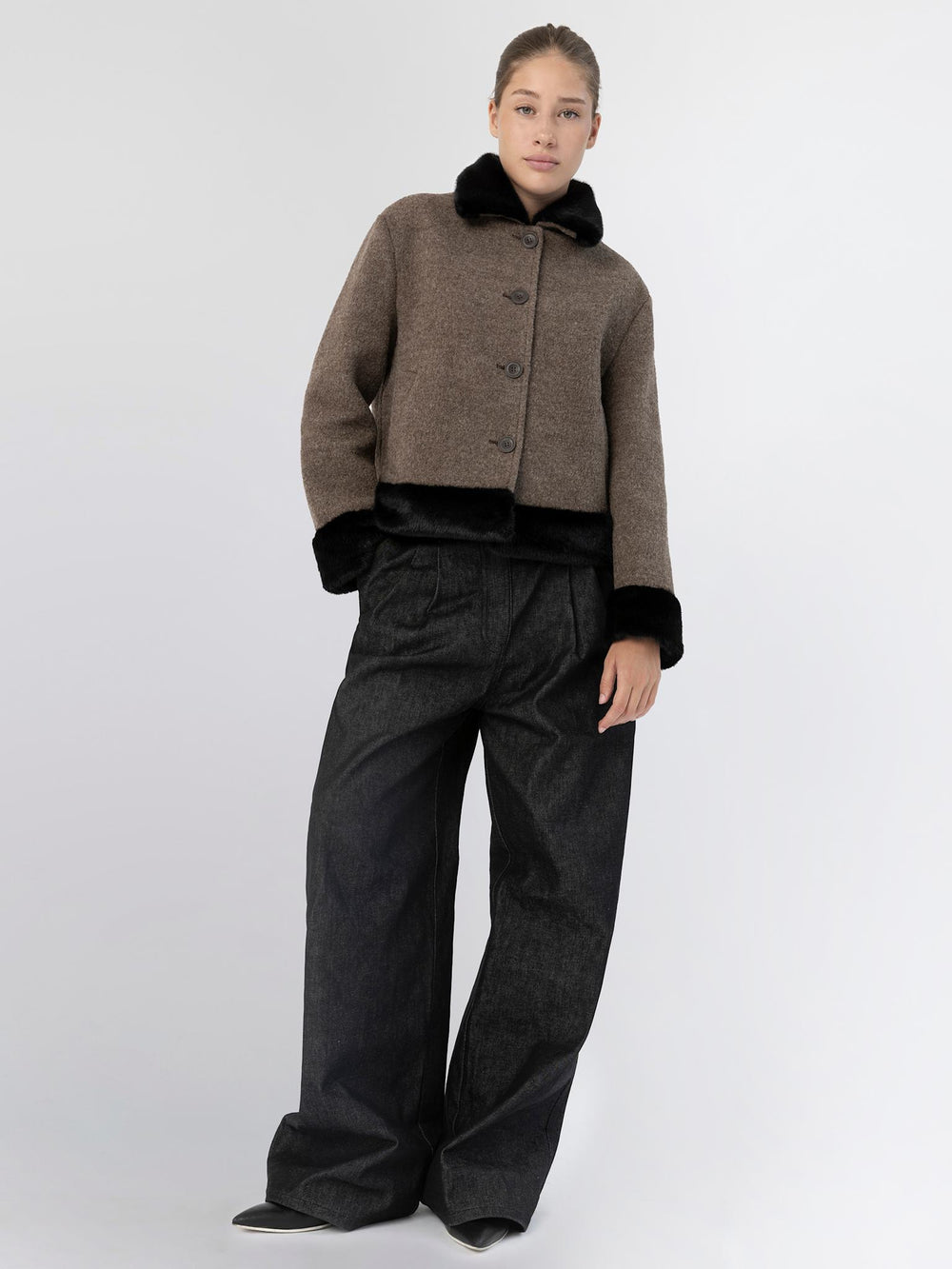 Stylish brown and black MEOTINE jacket with a faux fur collar, paired with blue jeans and a black handbag.