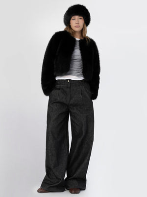 A model wearing a stylish black faux fur jacket, gray top, and wide-leg dark pants, showcasing MEOTINE's chic winter fashion.