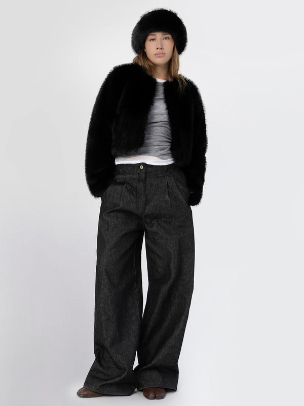 A model wearing a stylish black faux fur jacket, gray top, and wide-leg dark pants, showcasing MEOTINE's chic winter fashion.