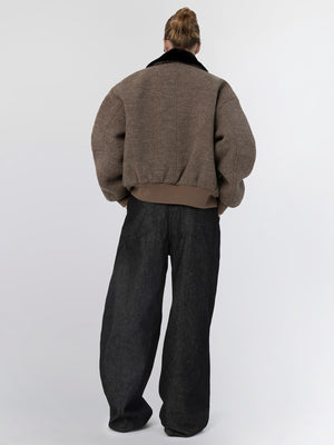 Oversized brown jacket with a black collar, paired with loose black pants, showcasing a relaxed, modern style by MEOTINE.