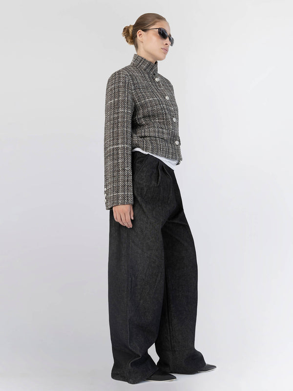 Stylish model wearing a cropped tweed jacket and wide-leg dark jeans, showcasing MEOTINE's contemporary fashion aesthetic.