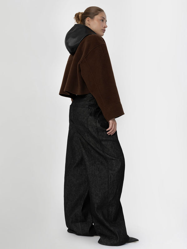 A model showcases a stylish brown cropped jacket with a black hood, paired with wide-leg black trousers, embodying MEOTINE's modern aesthetic.