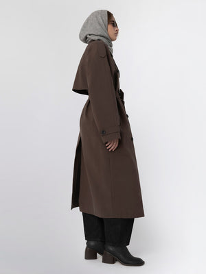 A model showcases a stylish brown trench coat paired with a gray hood, embodying modern elegance by MEOTINE.