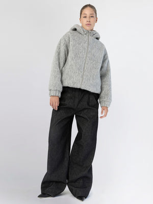 A model wears a cozy gray hoodie and wide-leg black pants, showcasing a stylish and comfortable look by MEOTINE.