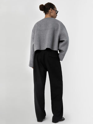 A model showcases a stylish gray cropped sweater paired with black wide-leg trousers, embodying MEOTINE's modern aesthetic.