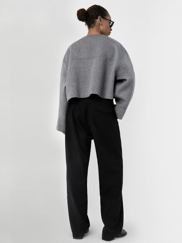 A model showcases a stylish gray cropped sweater paired with black wide-leg trousers, embodying MEOTINE's modern aesthetic.