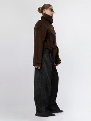 A model showcases a stylish brown oversized coat paired with wide-leg black trousers, embodying MEOTINE's modern aesthetic.