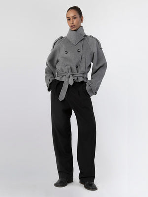 A model showcases a stylish gray double-breasted coat with a belted waist, paired with loose black trousers, embodying MEOTINE's chic aesthetic.