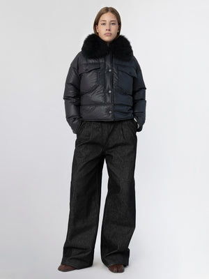 Stylish black puffer jacket with a fur collar, paired with wide-leg dark trousers, showcasing MEOTINE's modern winter fashion.