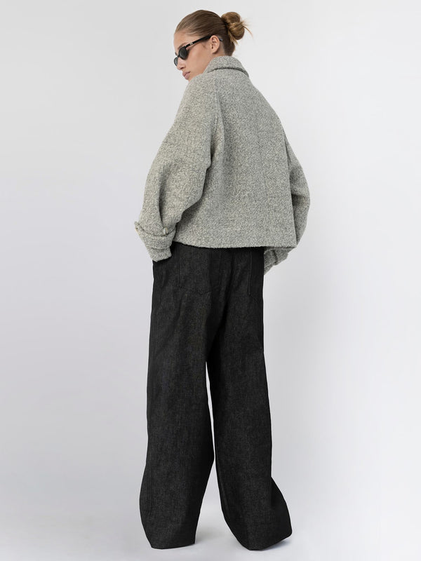 A model showcases a stylish gray oversized jacket paired with wide-leg black trousers, embodying MEOTINE's modern aesthetic.