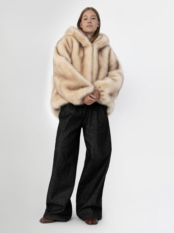 Cozy oversized beige fur hoodie paired with wide-leg black pants, showcasing a stylish and comfortable look by MEOTINE.