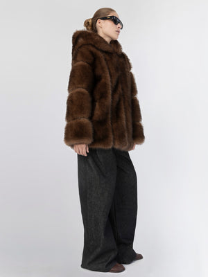 A model wears a luxurious brown fur coat paired with wide-leg dark jeans, showcasing MEOTINE's stylish winter fashion.