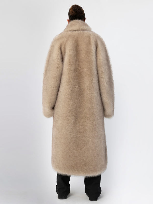 A model wearing a long, plush beige coat from MEOTINE, showcasing a cozy and stylish design from the back.