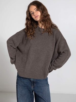 Cozy brown oversized sweater paired with relaxed denim jeans, showcasing a casual and stylish look by MEOTINE.