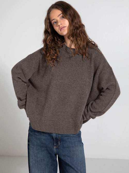 Cozy brown oversized sweater paired with relaxed denim jeans, showcasing a casual and stylish look by MEOTINE.