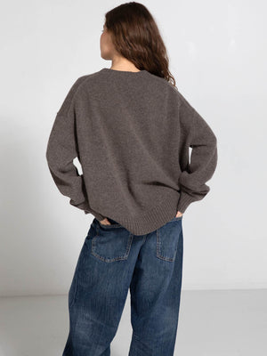 Cozy brown oversized sweater paired with loose blue jeans, showcasing a relaxed style perfect for casual wear by MEOTINE.