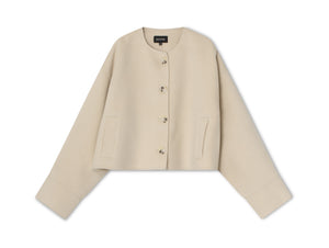Beige cropped jacket with a round neckline and button closure, featuring side pockets for a stylish touch by MEOTINE.