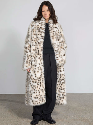 A model showcases a stylish MEOTINE faux fur coat with a leopard print, paired with a black top and wide-leg trousers.