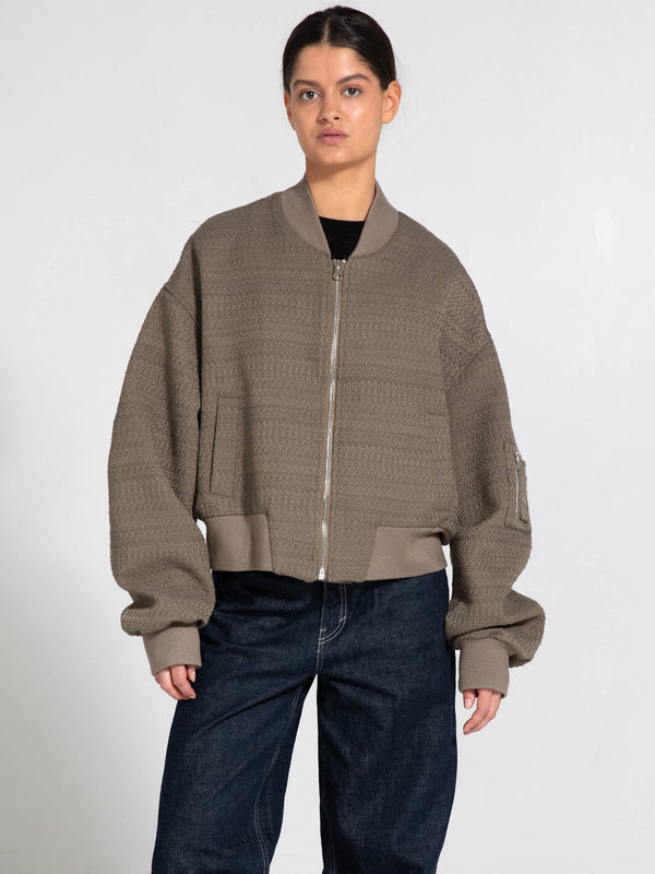 Stylish oversized bomber jacket in taupe with textured fabric and zip closure, perfect for a casual look by MEOTINE.