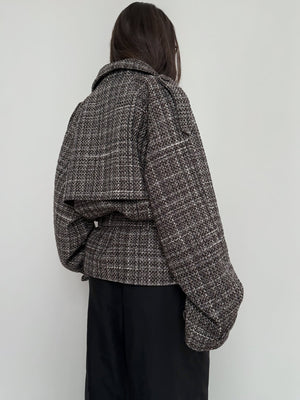 Stylish oversized tweed jacket in brown and black tones, featuring a unique back design. Perfect for a chic, modern look by MEOTINE.
