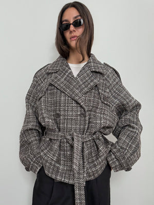 A model wears a stylish oversized gray and black textured jacket with a belt, showcasing a modern look by MEOTINE.