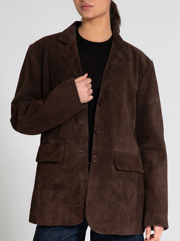 Brown suede blazer with a relaxed fit, featuring two front pockets and button closure, styled by MEOTINE.