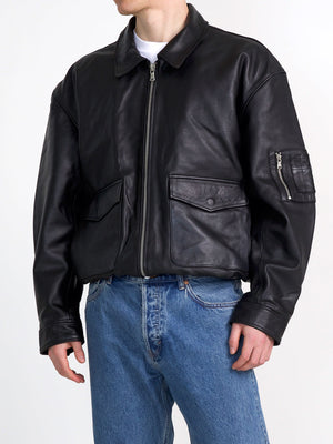 Stylish black leather bomber jacket with zip pockets, perfect for a modern look. Designed by MEOTINE for a trendy outfit.