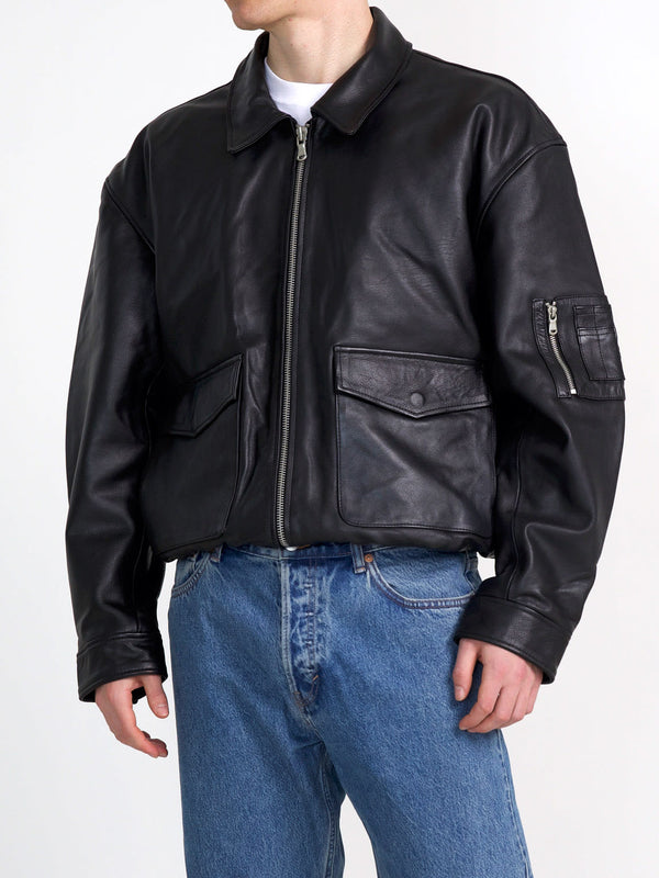 Stylish black leather bomber jacket with zip pockets, perfect for a modern look. Designed by MEOTINE for a trendy outfit.