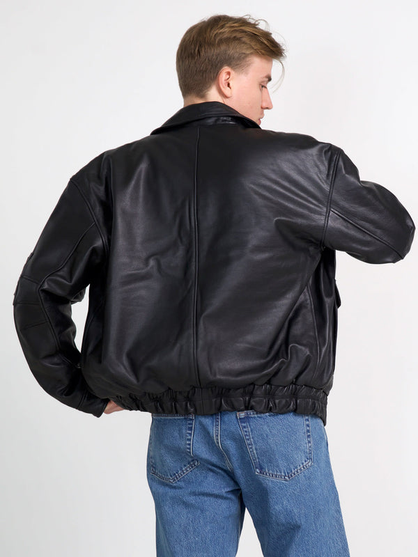 Stylish black leather jacket with a relaxed fit and elastic hem, perfect for a trendy look. By MEOTINE.